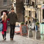 A young couple shop in the Grassmarket in Edinburgh, Scotland