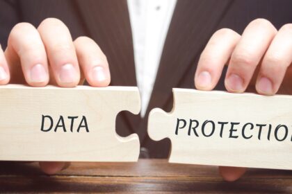 Businessman collects wooden puzzles with the word Data Protection