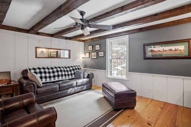 Comfortable sitting room furnished in vintage style with leather sofas, wood flooring and paintings