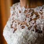 Detail of a white and elegant wedding dress.