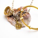 Golden jewelry with decorative seashell on the white background