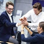 Group of business people celebrating success in office