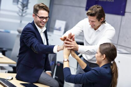 Group of business people celebrating success in office