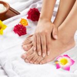 Hand on foot with healthy nails posing after a massage treatment