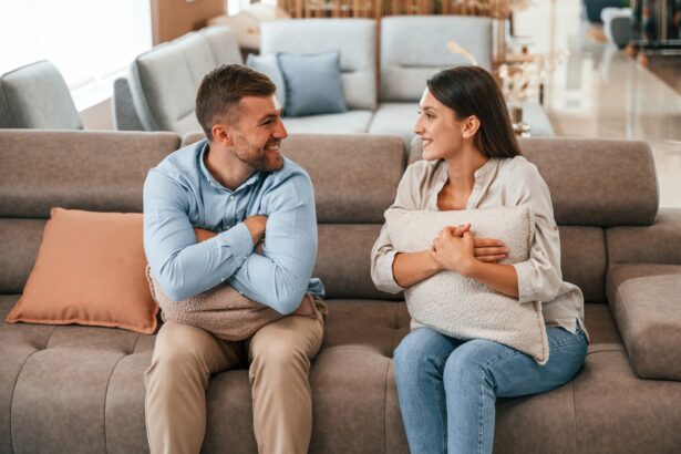 Happy couple choosing the sofa and bed in the store