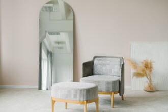 Modern Chair and Ottoman in Minimalist Interior with Large Mirror
