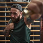 Muscular Man Throwing a Punch During Workout Session