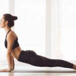Woman Performing Yoga Pose on Yoga Mat, Side View