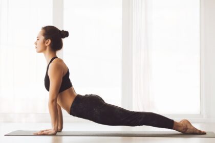 Woman Performing Yoga Pose on Yoga Mat, Side View