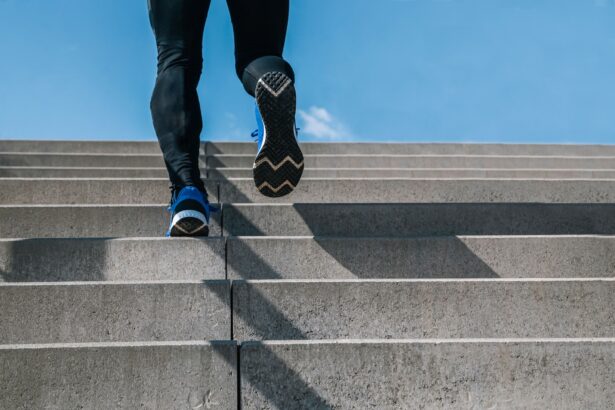 Young man exercising climbs stairs outdoors. Cut the view of strong and powerful legs