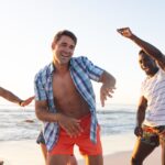Young men enjoy a lively moment on the beach